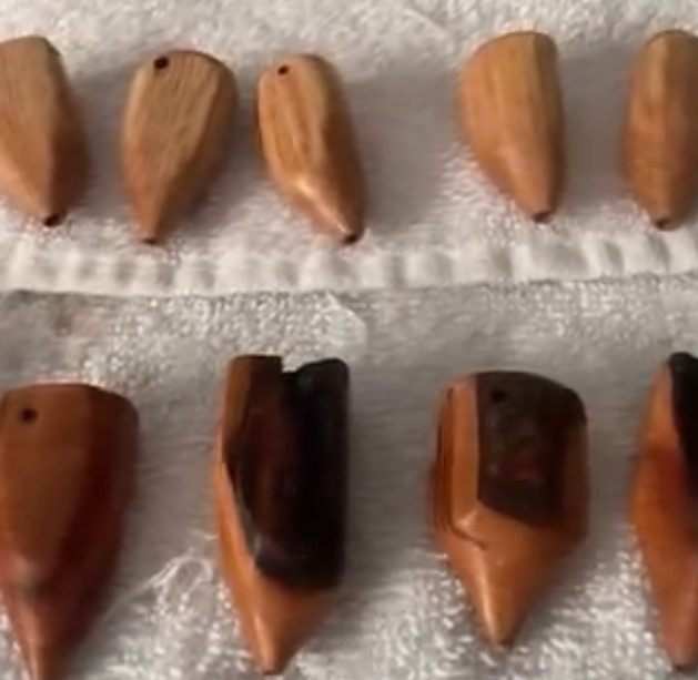 A batch of freshly carved wooden breathing trees laid out on a towel
